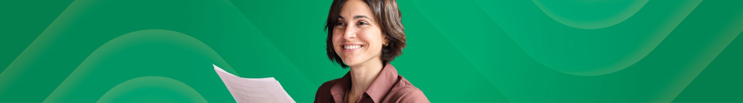 Woman smiling and holding documents.